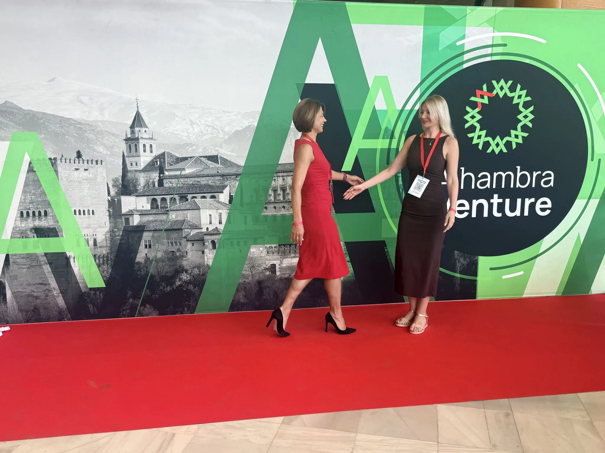 Marta Barandiy (right) and nuclear-security scholar Mariana Budjeryn on the Alhambra Venture red carpet in Granada, the Alhambra palace and Sierra Nevada behind them.